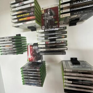 Organize Your Game Collection with Our Wall-Mounted Game Box Holder Keep your Xbox or PlayStation game boxes neatly stored and easily accessible with our 3D-printed wall-mounted game box holder. This sleek and modern design will not only help you declutter your gaming space but also add a touch of style. Features: Wall-Mounted Design: Saves space and keeps your game boxes within reach. Customizable: Can be designed to fit various game box sizes and quantities. Durable Construction: Made from high-quality materials for long-lasting use. Sleek and Modern Design: Adds a touch of style to your gaming setup. Upgrade your gaming experience with our 3D-printed wall-mounted game box holder.