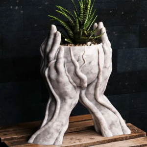 Nurture Your Green Thumb with Our 2 Hands With Roots Holding Planter Add a touch of whimsy and nature to your home decor with our unique 2 Hands With Roots Holding Planter. Available in up to 32 vibrant colors, this planter is the perfect way to display your favorite plants. Key Features: Unique Design: A captivating sculpture that doubles as a functional planter. Versatile Use: Ideal for succulents, herbs, or small houseplants. Durable Material: Crafted from high-quality, weather-resistant materials. Colorful Options: Choose from a wide range of colors to match your style. Easy to Care For: Simple to plant and maintain. Bring a touch of nature indoors and elevate your space with our 2 Hands With Roots Holding Planter.