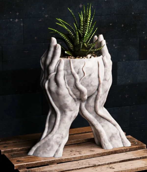 Nurture Your Green Thumb with Our 2 Hands With Roots Holding Planter Add a touch of whimsy and nature to your home decor with our unique 2 Hands With Roots Holding Planter. Available in up to 32 vibrant colors, this planter is the perfect way to display your favorite plants. Key Features: Unique Design: A captivating sculpture that doubles as a functional planter. Versatile Use: Ideal for succulents, herbs, or small houseplants. Durable Material: Crafted from high-quality, weather-resistant materials. Colorful Options: Choose from a wide range of colors to match your style. Easy to Care For: Simple to plant and maintain. Bring a touch of nature indoors and elevate your space with our 2 Hands With Roots Holding Planter.