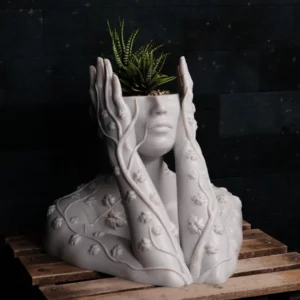 Elevate your indoor garden with our stunning 3D printed planter, featuring a delicate bust of a woman with ivy gracefully climbing up her arms. This unique piece is not only a functional planter but also a captivating work of art.Key Features: Intricate Design: Admire the intricate details of the woman's bust and the flowing ivy. Functional Planter: Perfect for showcasing your favorite plants, from succulents to trailing vines. Durable and Eco-Friendly: Crafted from high-quality, 3D printed plastic. Versatile Display: Can be used as a standalone piece or as part of a larger plant arrangement. Unique Gift: Surprise a loved one with this extraordinary gift for plant enthusiasts and art lovers. Bring nature indoors and add a touch of elegance to your home with our 3D printed planter.